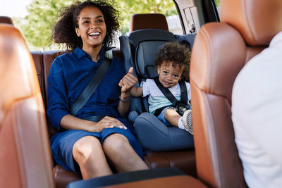 Mother with son sitting in car