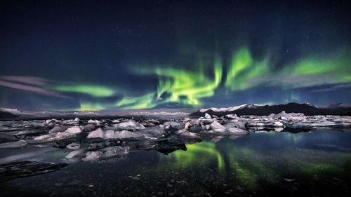 Scenic view of landscape against sky at night