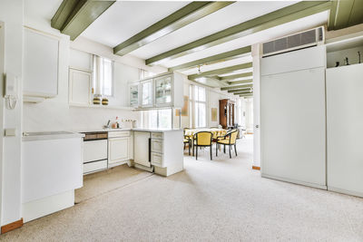 Empty chairs and tables in modern room