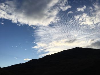 Low angle view of silhouette mountain against sky