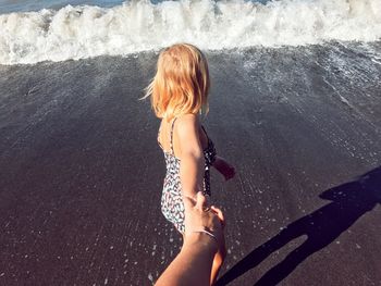 Rear view of woman standing in water