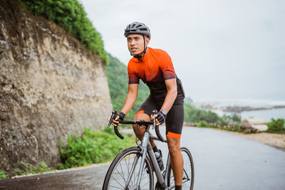 Man riding bicycle on road