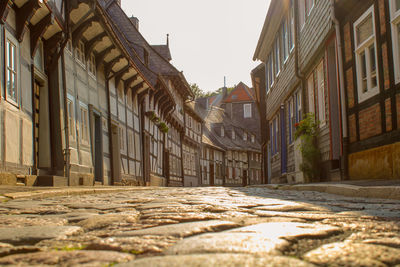 Surface level of street amidst buildings against sky