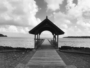 Pier over sea against sky