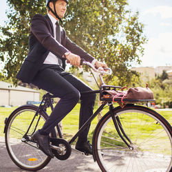 Businessman riding bicycle on street