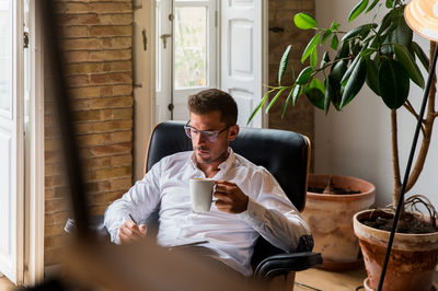 Young man sitting on table