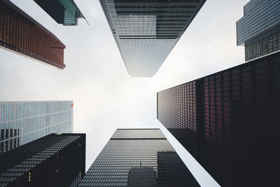 Low angle view of modern buildings in city against sky