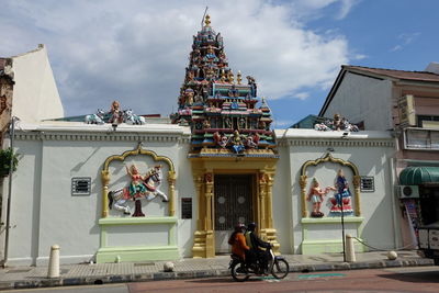 Statue outside temple against building