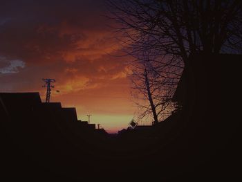 Low angle view of silhouette built structure against sky at sunset