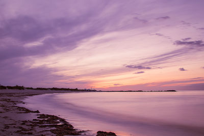 Scenic view of sea against romantic sky at sunset