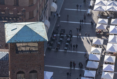 High angle view of people on street by buildings