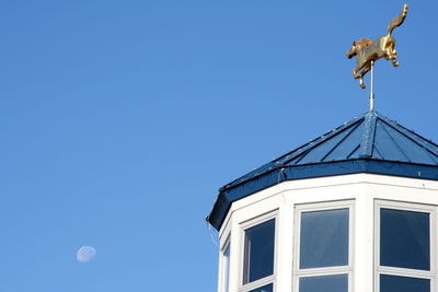 Low angle view of built structure against clear blue sky