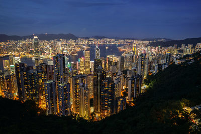 High angle view of city lit up at night