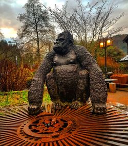 Statue in park against sky