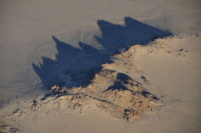 High angle view of footprints on sand at beach