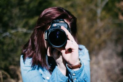 Portrait of woman photographing