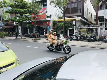 Man riding motor scooter on city street