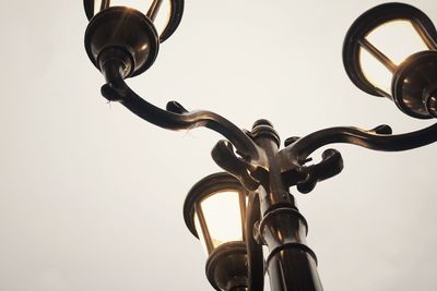 Low angle view of electric lamp against sky