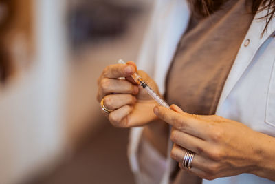 Close-up of woman hand holding cigarette