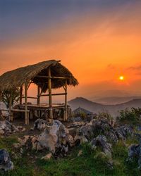 Built structure on land against sky during sunset