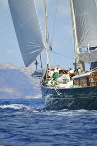 Boat sailing in sea against sky