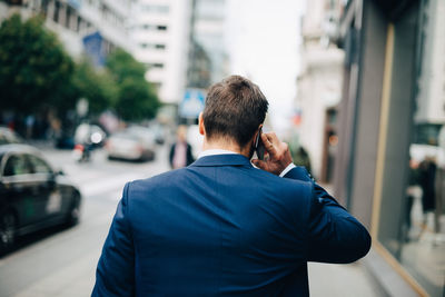 Rear view of man on street in city