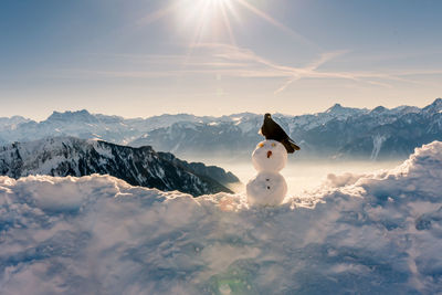 Snow covered mountain range against sky