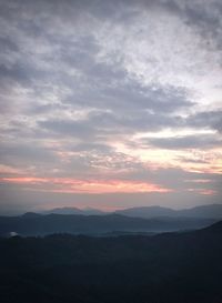 Scenic view of silhouette mountains against sky during sunset