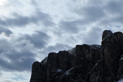 Low angle view of rocky mountains against sky