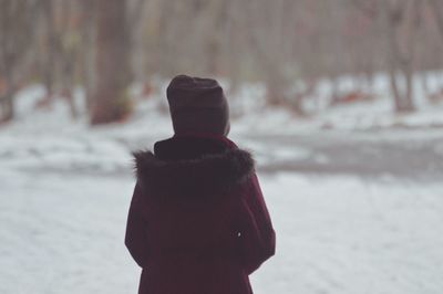 Rear view of woman standing during winter