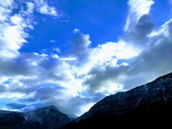 Low angle view of mountains against blue sky
