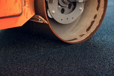 Close-up of road roller on asphalt