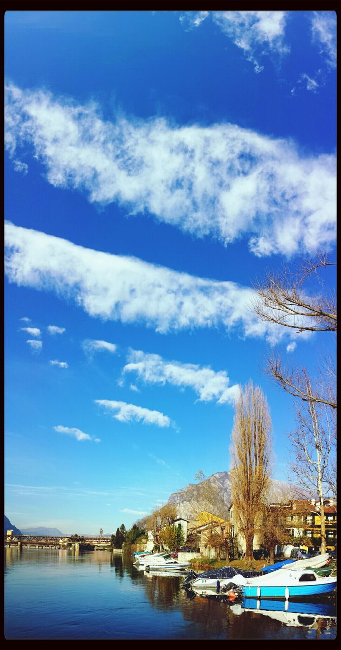 sky, water, transfer print, nautical vessel, blue, waterfront, cloud - sky, transportation, mountain, lake, cloud, mode of transport, tranquil scene, auto post production filter, scenics, tranquility, nature, beauty in nature, snow, boat