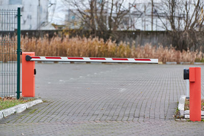 Parking gate, automatic car barrier system for car-park security. white red boom gate.