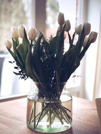 Close-up of flower vase on table at home