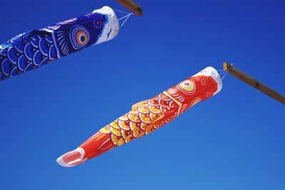 Low angle view of fish against blue sky