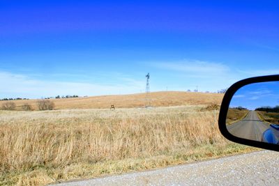 Scenic view of field against clear blue sky