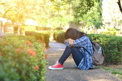 Sad woman sitting on the ground