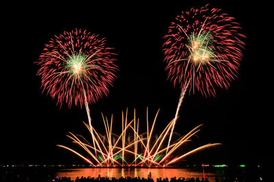 Low angle view of firework display at night