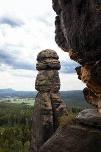 Stack of rocks on mountain against sky