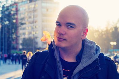 Portrait of young man in city during winter