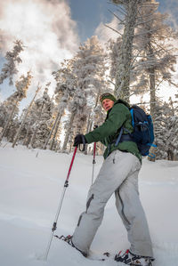 Low angle view of man skiing on snow covered land