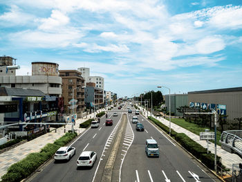 High angle view of vehicles on road along buildings