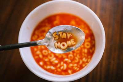 Stay home letter soup on spoon