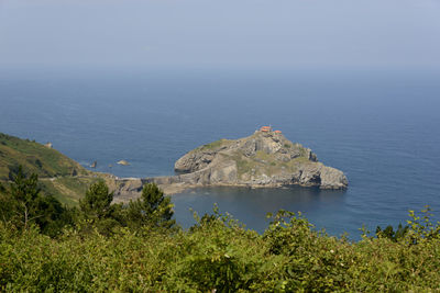 High angle view of sea and trees against sky