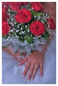 Midsection of woman with red roses