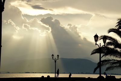 Scenic view of silhouette palm trees against sky during sunset
