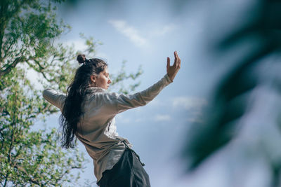 Low angle view of woman against sky