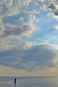 View of calm sea against cloudy sky