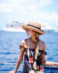 Young woman in boat against sea